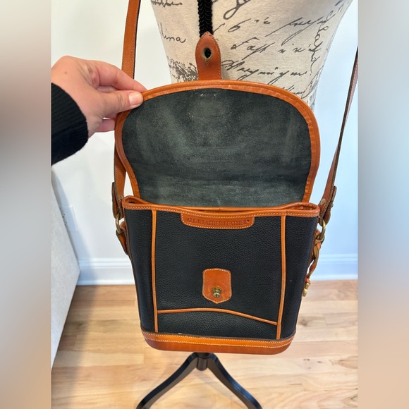 Dooney & Bourke All-Weather Leather Dover crossbody bag in black with brown trim - Picture 9 of 16